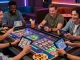 Mega888 download showcased by friends enjoying a lively casino gaming experience with tablets and smartphones.