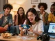 Friends excitedly gather to download Card Rummy APK on Android, showcasing a lively gaming atmosphere.